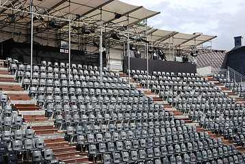 Image showing rows of empty black plastic seats 