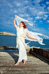 Image showing  beautiful woman  in white on seacoast