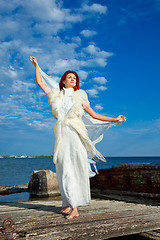 Image showing  beautiful woman  in white on seacoast