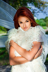 Image showing beautiful woman in white in a park