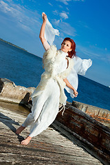 Image showing  beautiful woman  in white on seacoast