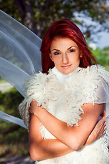 Image showing beautiful woman in white against blue sky and green trees