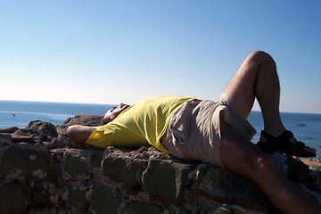 Image showing man laying on historical building