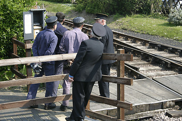 Image showing men train watching