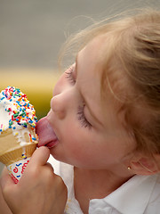 Image showing girl licking ice cream cone