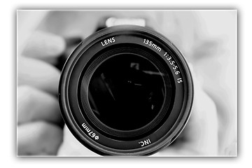 Image showing photographing lens in the hands of the photographer