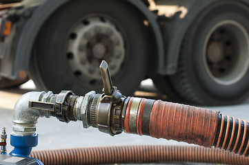 Image showing Truck Hoses for fuel station, pumps and oil barrels