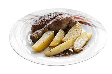 Image showing Roasted chicken leg with potatoes