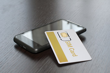 Image showing SIM card and mobile phone