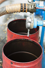 Image showing Truck Hoses for fuel station, pumps and oil barrels