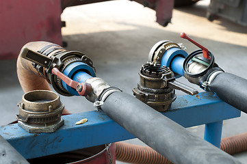 Image showing Truck Hoses for fuel station, pumps and oil barrels