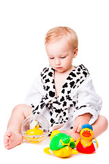 Image showing baby boy playing with  toys after bathing