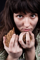 Image showing poor beggar woman with a piece of bread