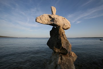 Image showing Cross, rocks stacked one one top of another on beach