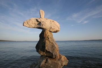 Image showing Cross, rocks stacked one one top of another on beach