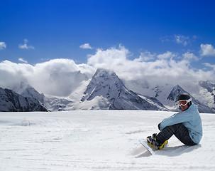 Image showing Snowboarder resting on the ski slope