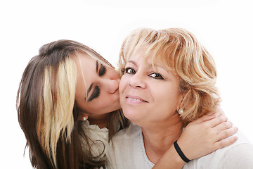 Image showing Closeup of young girl kissing her mom isolated on a white backgr