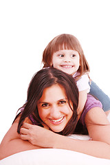 Image showing mom and her little girl playing on pillow