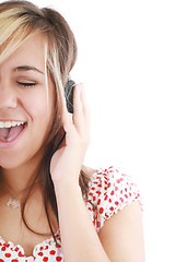 Image showing pretty casual brunette is listening to music on white background