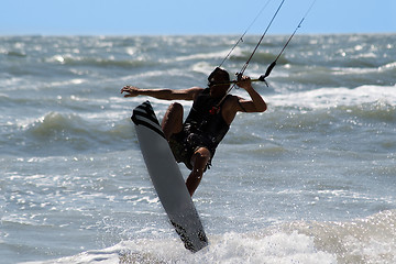 Image showing Kite surfer jumping and flying high