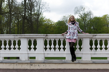 Image showing blonde girl is leaning on railing