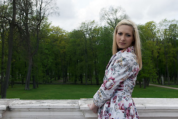Image showing blonde girl standing against a background of park