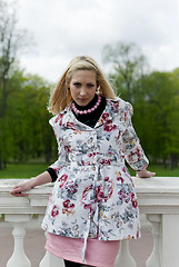 Image showing blonde girl is leaning on railing