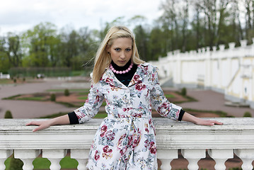 Image showing blonde girl is leaning on railing