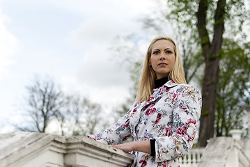 Image showing blonde girl is leaning on railing