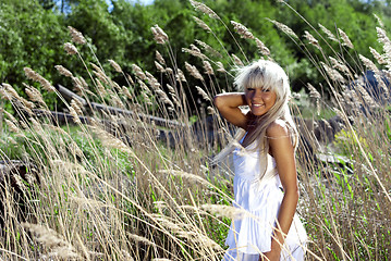 Image showing girl are standing in dry grass