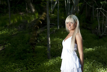 Image showing girl standing in a dark forest