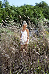 Image showing girl are standing in dry grass