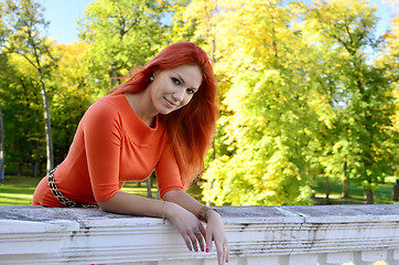 Image showing Redhead girl standing at the railing