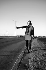 Image showing girl on the road waiting for a car, black and white photo