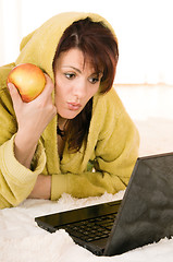 Image showing woman with laptop and apple