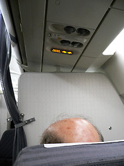 Image showing Bald headed passenger on aeroplane.