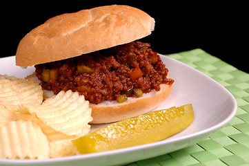 Image showing Sloppy Joe sandwich with chips and pickle