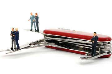 Image showing business people on penknife