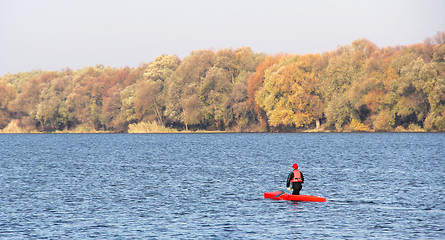 Image showing Man in a red canoe