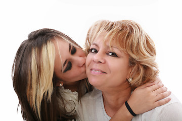 Image showing Closeup of young girl kissing her mom isolated on a white backgr