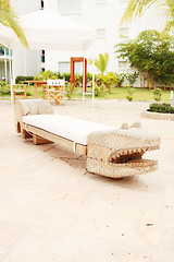 Image showing Home exterior patio with handcraft wooden sofa with an aligator 