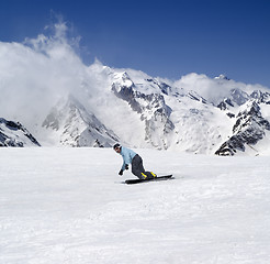 Image showing Snowboarding in mountains