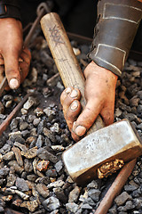 Image showing Detail of dirty hands holding hammer - blacksmith