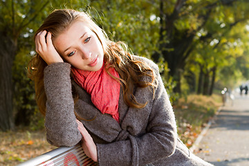 Image showing Thoughtful  girl on a bench