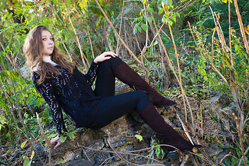 Image showing Girl sitting on a stones