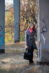 Image showing Girl standing near concrete post