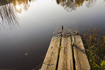 Image showing Broken and hollow in water abandoned wooden bridge