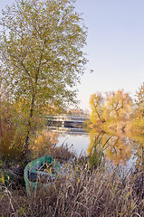 Image showing Wooden boat locked near river. Autumn morning view