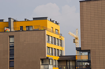 Image showing Modern houses and crane between it. Construction.