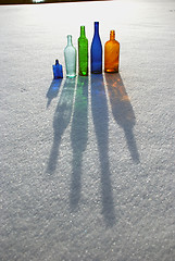 Image showing Colored bottles on snow 